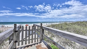 A wooden boardwalk leading to a beach with a clear view of the ocean and a cloudy sky. - Ocean-View Fernandina Condo w/ Pool, Beach Access! (Fernandina Beach)