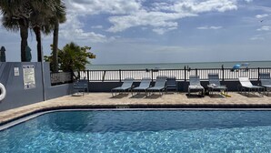A pool area with lounge chairs and a view of the ocean. - Unwind Together with a Beachfront View, Beach, Pool. 6th Floor. Tickets to Top Attractions Daily (Madeira Beach)