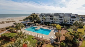 A hotel with a large pool, beach view, and multiple balconies. - Luxury ocean view condo located in Wild Dunes with direct beach access (Isle of Palms)