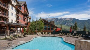 A pool area with lounge chairs and a view of mountains. - Professionally Decorated Peregrine Point Steps to Lifts (Durango)