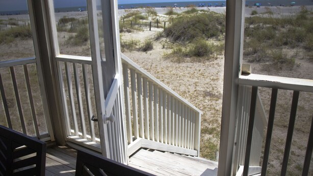 A wooden deck with a view of the beach and dunes. - Oceanfront 1st floor condo with direct beach access from private porch (Isle of Palms)