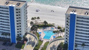 A resort with a pool, beach, and palm trees. - Amazing 9th Floor Beachfront View From Private Balcony. Pool/HotTub, Beach, + Tickets to Fun Daily! (Madeira Beach)