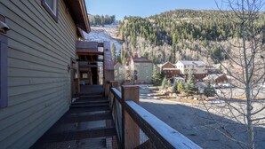 A wooden building with a balcony overlooking a snowy landscape and a forested hill. - DOUBLE DIAMOND 3- Condo with Loft, Telluride near Chair 7 and Shuttle Route (Telluride)