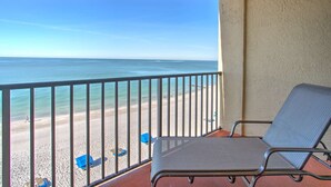 A balcony with a metal railing overlooking a beach. - Beachfront Condo With Private Balcony Overlooking the Sand! Relax on the Beach or Lounge in the Pool (Madeira Beach)