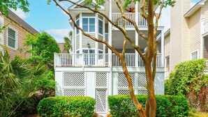 A two-story building with a balcony and a lattice fence.