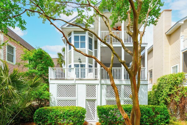 A two-story building with a balcony and a lattice fence.