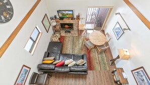 A spacious living area with a fireplace, a television, and a comfortable seating arrangement.