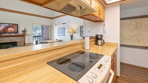 A kitchen with wooden cabinets, a built-in stove, and a coffee maker.