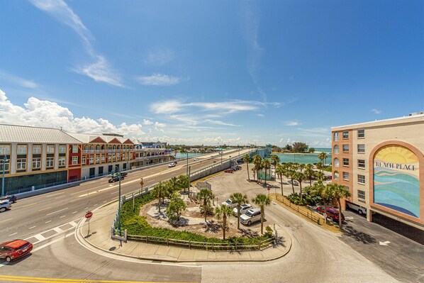 A coastal cityscape with a prominent building labeled "BEACH PLACE" featuring a mural of a beach scene.