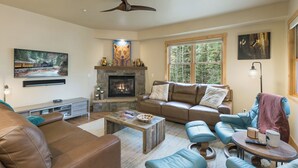 A cozy living room with a fireplace, leather sofas, and a stone fireplace surround. - Largest Black Bear Townhome - Ping Pong Table - on Demand Ski Shuttle (Durango)