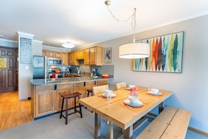 The open kitchen overlooks the dining area and the breakfast bar is the perfect place to enjoy your morning coffee.