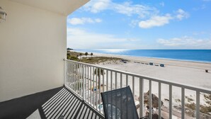 A balcony with a view of a beach and ocean. - Direct Beachfront - Hot Tub  - Sea Breeze #308 (Madeira Beach)