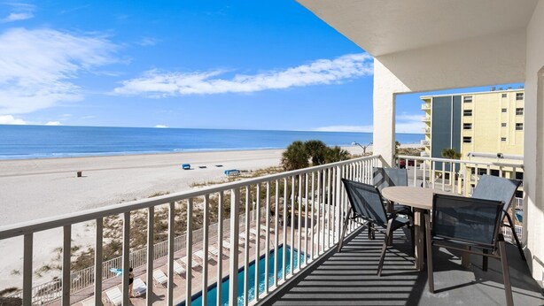 A balcony with a view of a beach and ocean. - Direct Beachfront - Hot Tub  - Sea Breeze #308 (Madeira Beach)