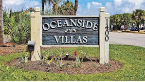 A sign for Oceanside Villas with a simple, elegant design. - Cozy Condo Steps From the Water! (Isle of Palms)