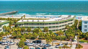 A coastal hotel with a beach view, parking lot, and a pier. - Oceanfront Condo with Private Balcony & Outstanding Ocean Views (Isle of Palms)