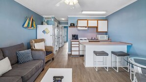 A compact living space with a kitchenette, a dining area, and a seating area. - Oceanfront Condo with Private Balcony & Outstanding Ocean Views (Isle of Palms)