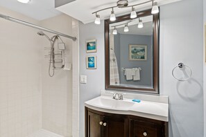Combined shower/bathtub, hair dryer, towels - Coastal Decor - Top Floor View - Crimson #303 (Madeira Beach)