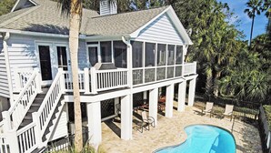 A two-story house with a covered patio and a swimming pool. - Beautiful home in Wild Dunes with a private pool and close beach access (Isle of Palms)