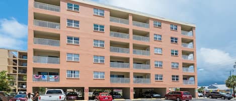 A multi-story building with a parking garage.