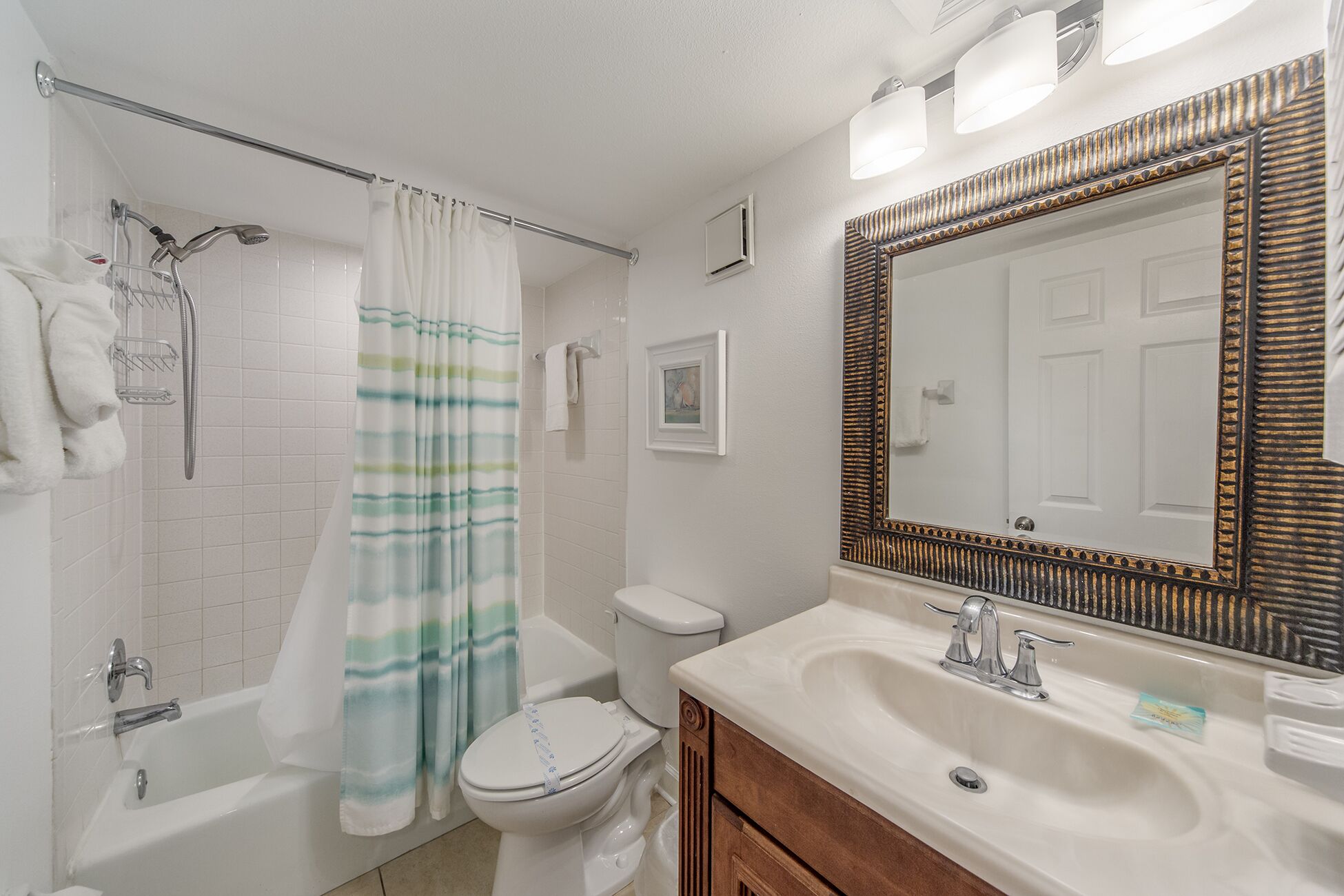A bathroom with a shower, toilet, and sink.