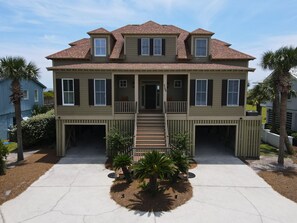 A two-story house with a front porch, a covered front entrance, and a driveway.