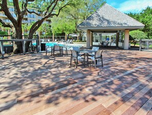 An outdoor patio with a pool, lounge chairs, and a gazebo. - Outstanding condo in Wild Dunes with oceanfront decks and pool access (Isle of Palms)