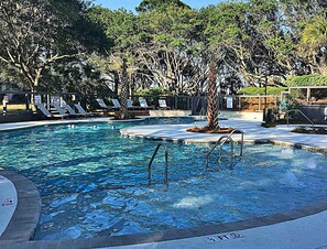 A swimming pool with multiple lanes, surrounded by lounge chairs and trees. - Outstanding condo in Wild Dunes with oceanfront decks and pool access (Isle of Palms)