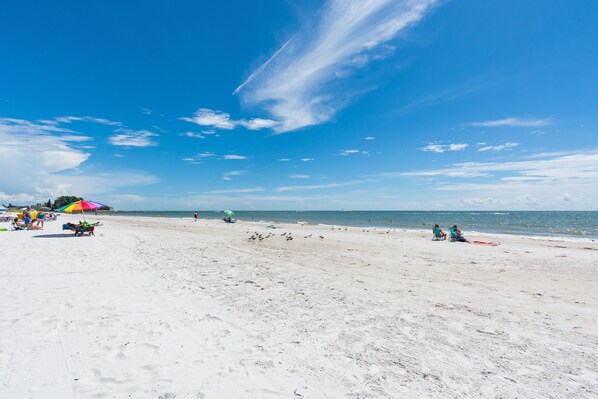 Relax on the beach with comfortable seating and ocean views.