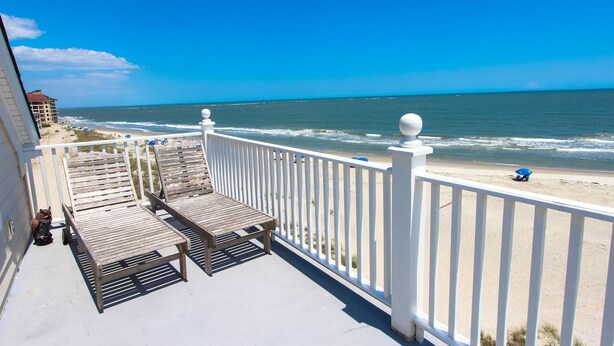 A balcony with a view of the beach and ocean. - Three story home with sweeping ocean views and game room in Wild Dunes (Isle of Palms)