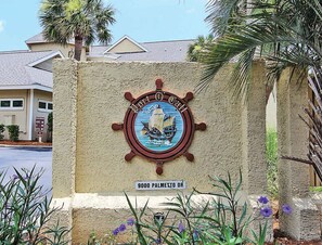 A building with a sign indicating 'Port of Port' and '9000 Palmetto Dr.'