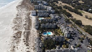 An aerial view of a coastal hotel with multiple buildings, a swimming pool, and a beach. - Ocean View condo in Wild Dunes (Isle of Palms)