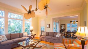 A spacious living room with two sofas, a coffee table, and a patterned rug. - Beautifully decorated and spacious home in Wild Dunes with a private pool (Isle of Palms)