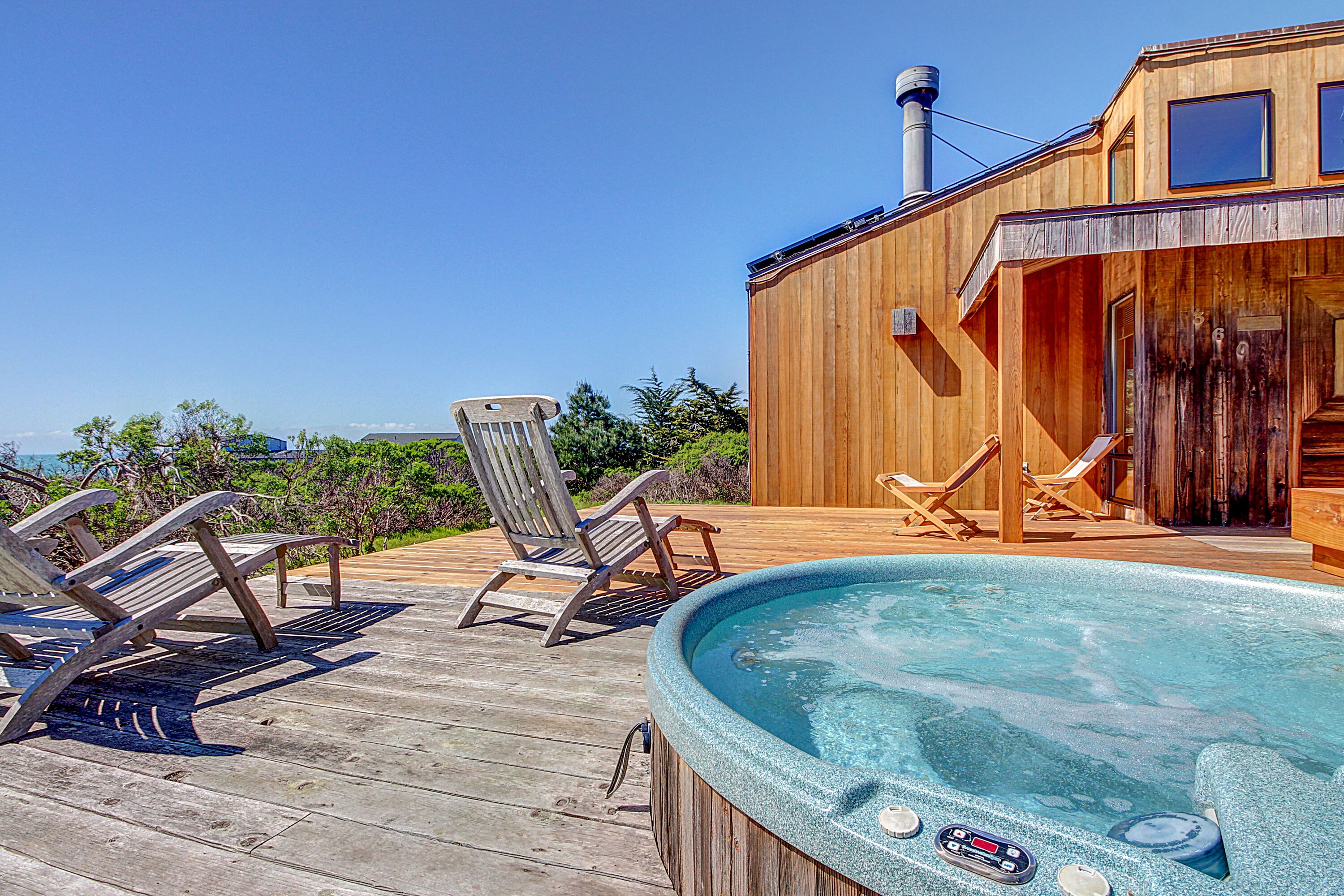 Contemporary coastal home with private hot tub, shared pool, & ocean views