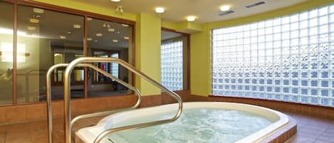 A hot tub with a metal ladder, a tiled floor, and a window with a grid pattern.