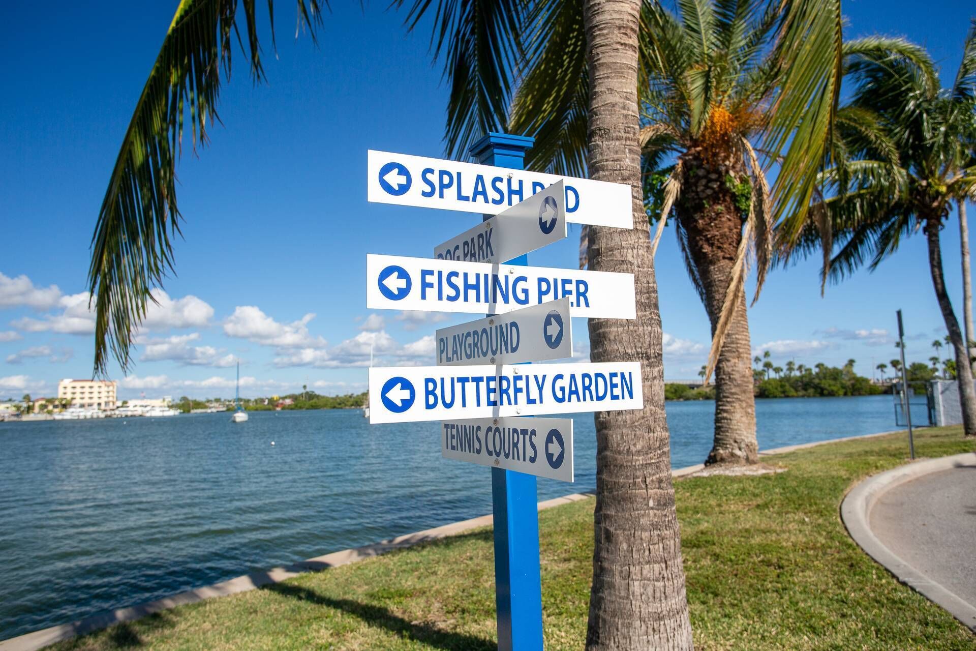 A signpost with directions to Splash Park, Fishing Pier, Playground, Butterfly Garden, and Tennis Courts.