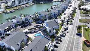 A coastal hotel with multiple buildings, a marina, and a swimming pool. - 2-Level Madeira Beach Condo, Pool, Marina, Walk to Beach, Shops,  Dining +Tickets to Top Activities! (Madeira Beach)