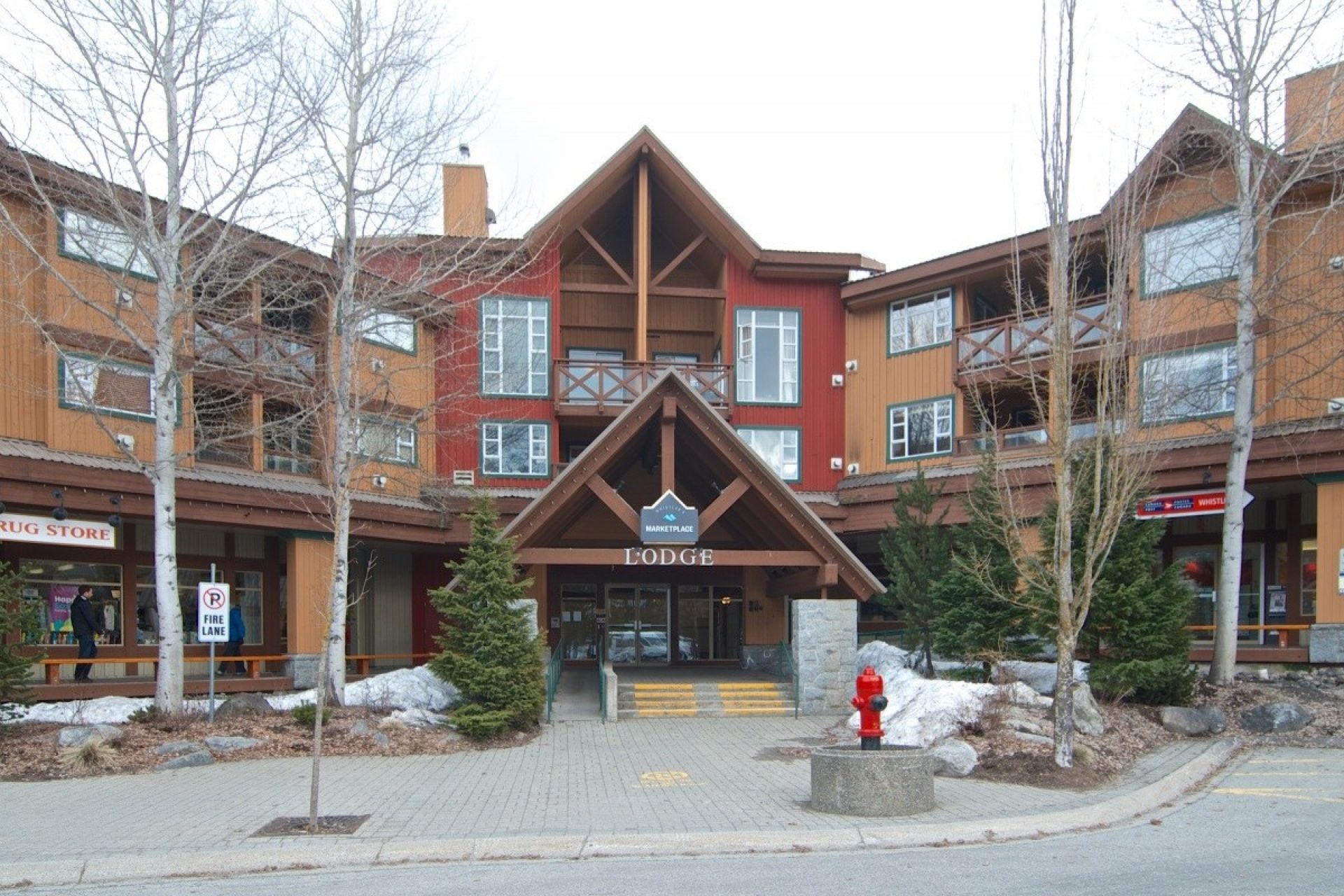 A lodge with a prominent 'Lodge' sign, a fire hydrant, and a 'No Parking' sign.