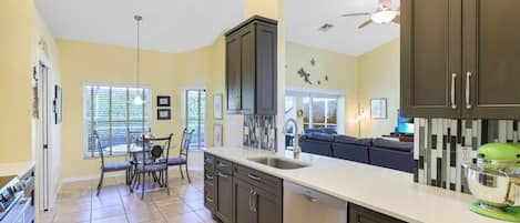 Enjoy meals in the kitchen with a dining area, kitchen island, and sink.