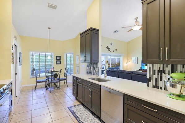 Enjoy meals in the kitchen with a dining area, kitchen island, and sink.