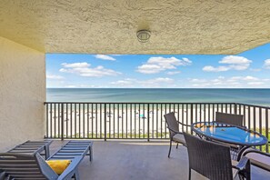 A balcony with a view of the beach and ocean. - Inviting Beachfront Condo | Pool, Spa & Views (Marco Island)