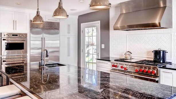 A modern kitchen with stainless steel appliances, a marble island, pendant lighting, and a large window. - Southern-Style Home w/ Luxe Kitchen: 15 Min to DC! (Arlington)