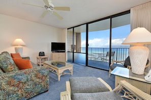 Relax on the balcony with a view of the sea, enjoying the seating area and flat-screen TV.
