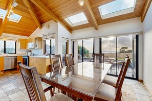 Enjoy meals in this dining area with a large glass table and comfortable seating.