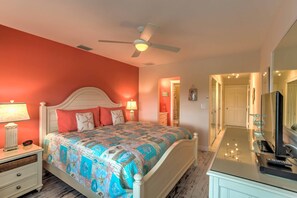 A bedroom with a bed, nightstand, lamp, and a ceiling fan. - Waterfront Sunset Suite: Dolphins, Docks & Pool! (Marco Island)