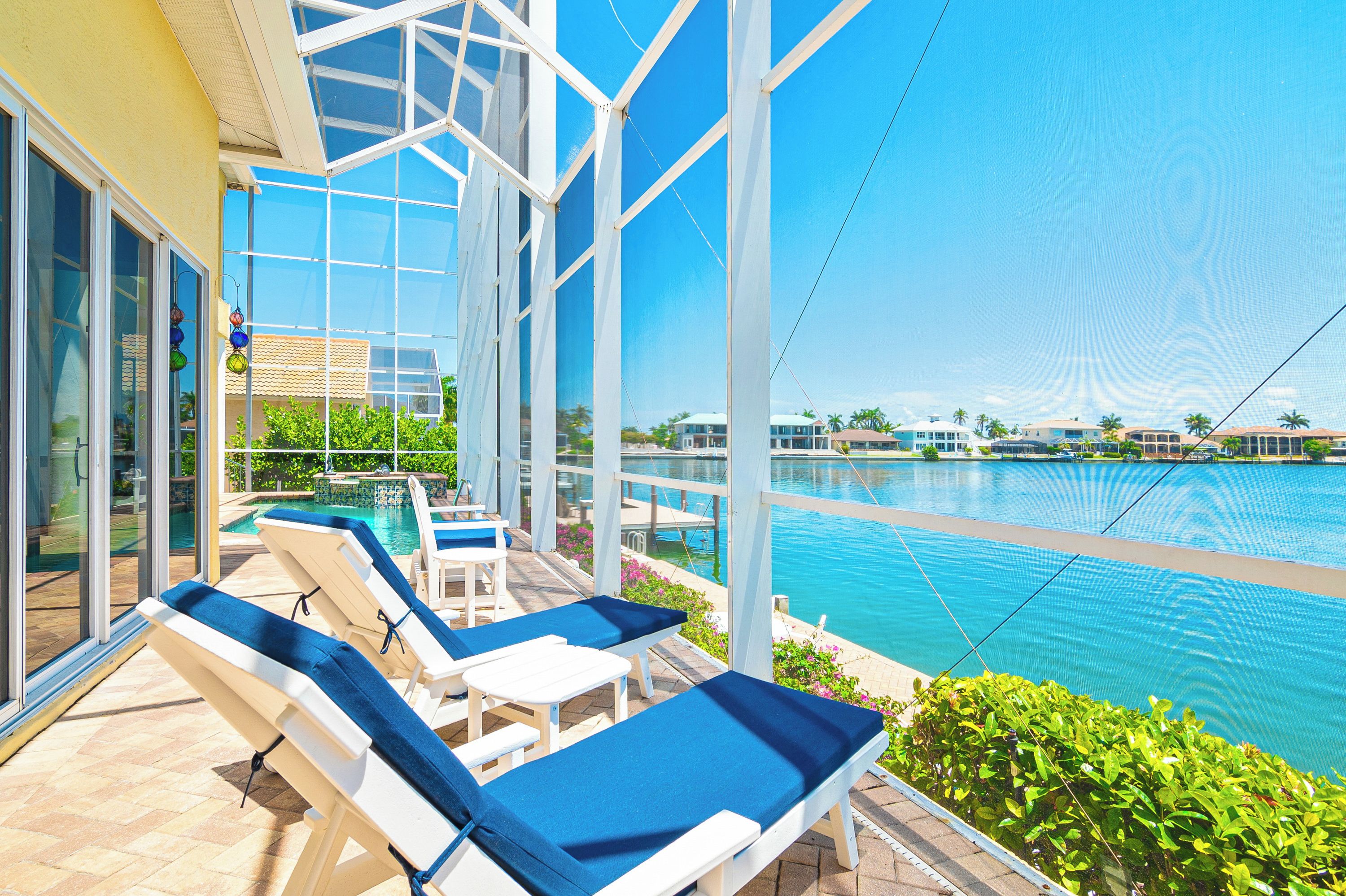 A poolside area with lounge chairs and a view of the pool.