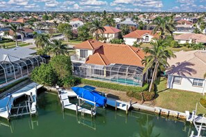 A residential area with houses, a dock, and a swimming pool.