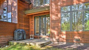 A wooden cabin with large windows, a covered grill, and a small table. - Forest-View Gem 2 Mi to Diamond Peak Ski Resort! (Incline Village)