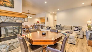 A spacious living room with a fireplace, a dining area with a large wooden table, and a modern kitchen in the background. - Forest-View Gem 2 Mi to Diamond Peak Ski Resort! (Incline Village)