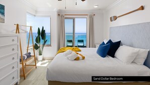 A bedroom with a bed, a ceiling fan, a view of the ocean, a wooden rack, and a potted plant. - Single Family Beachfront Home, Private Beach P1735-0 (Oceanside)