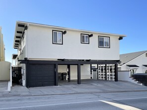 A two-story house with a garage and a covered driveway. - Quaint Beachside Escape P1615-4 (Oceanside)